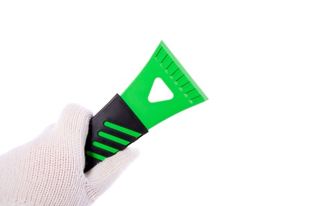 Hand holding an ice scraper isolated on white background