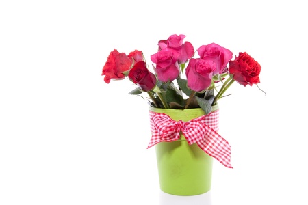 pink and red roses in a green vase isolatedの写真素材