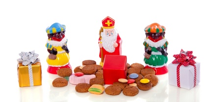 Traditional Dutch Sinterklaas and Piet with gingernuts and gifts to celebrate five december isolated over white backgroundの写真素材