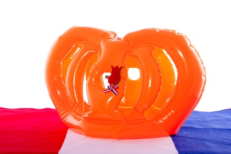 A plastic Dutch crown on a traditional flag for the celebration of Queensday