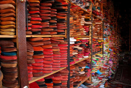 Traditional, colourful leather shoes stacked floor to ceiling in Fes, Moroccoの写真素材