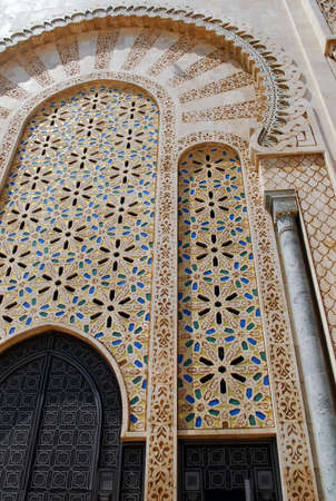 Door and arch with columns decorated with ornate mosaic detail at the Hassan II Mosque in Casablanca, Moroccoの写真素材
