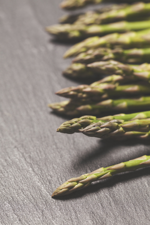 Fresh asparagus on a rustic slate backgroundの写真素材