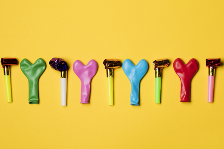 Party balloons on a bright yellow backgroundの写真素材