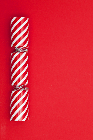 Christmas crackers on a red backgroundの写真素材
