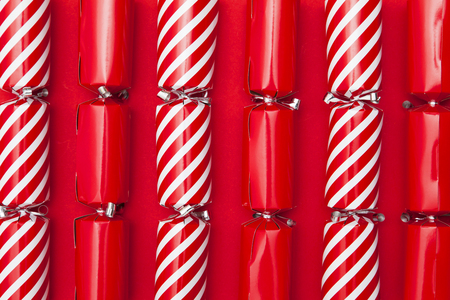 Christmas crackers on a red backgroundの写真素材