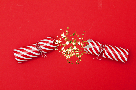 Christmas crackers on a red backgroundの写真素材