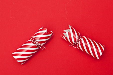 Christmas crackers on a red backgroundの写真素材