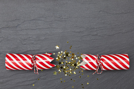 Christmas crackers on a slate background crackersの写真素材