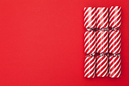 Christmas crackers on a red backgroundの写真素材