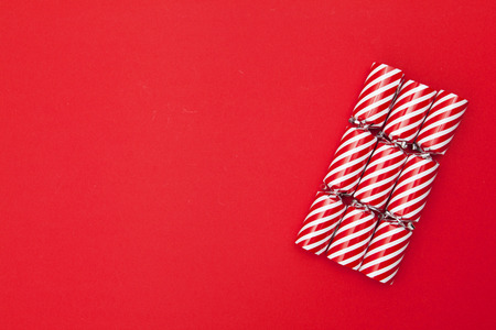 Christmas crackers on a red backgroundの写真素材