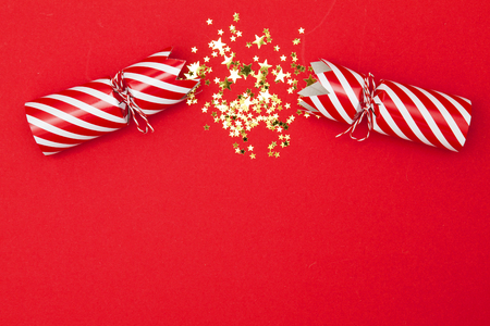 Christmas crackers on a red backgroundの写真素材