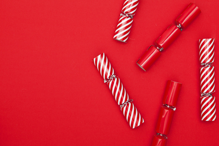 Christmas crackers on a red backgroundの写真素材
