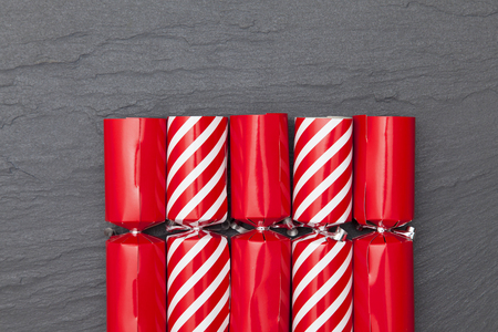 Christmas crackers on a slate background crackersの写真素材