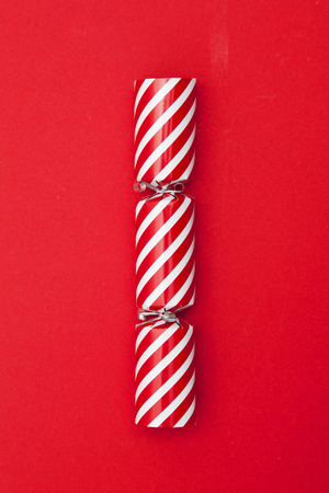 Christmas crackers on a red backgroundの写真素材