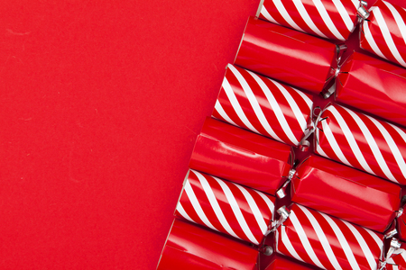 Christmas crackers on a red backgroundの写真素材