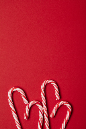Christmas festive candy cane on a red backgroundの写真素材