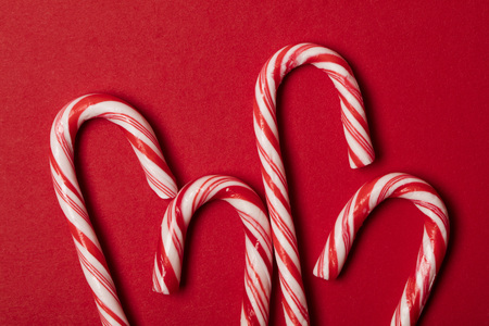 Christmas festive candy cane on a red backgroundの写真素材