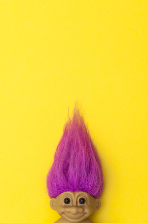 LONDON, UK - DECEMBER 4th 2017: An original troll plastic toy figure with bright coloured hair. First produced in Denmark by Thomas Damのeditorial素材