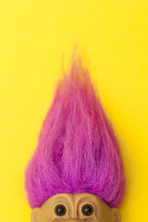 LONDON, UK - DECEMBER 4th 2017: An original troll plastic toy figure with bright coloured hair. First produced in Denmark by Thomas Damのeditorial素材