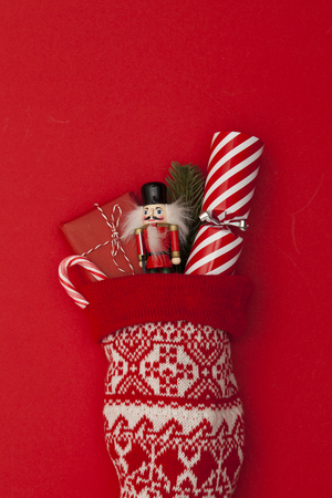 Christmas stocking with cracker, toy and wrapped presentの写真素材