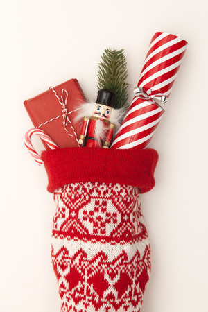 Christmas stocking with cracker, toy and wrapped presentの写真素材