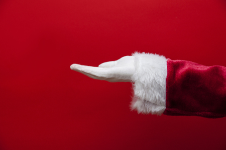 Santa Claus empty hand against a red backgroundの写真素材