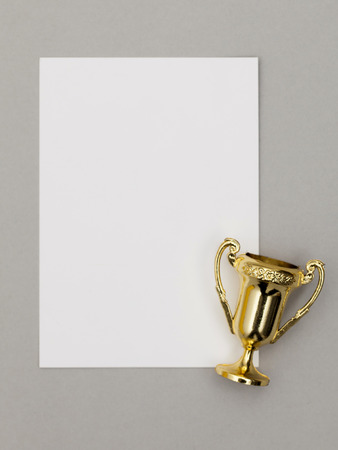 Gold winners trophy with blank certificateの写真素材