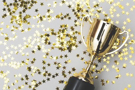 Gold winners trophy with golden shiny starsの写真素材