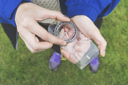 Female explorer with a compass in her hand. Point of viewの写真素材