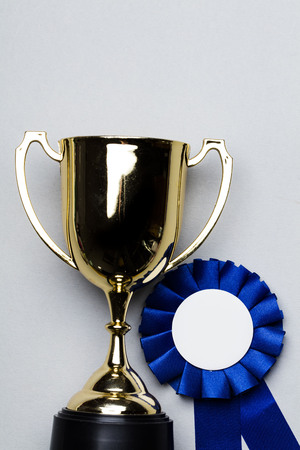 Gold trophy and winner rosetteの写真素材