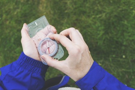 Female explorer with a compass in her hand. Point of viewの写真素材