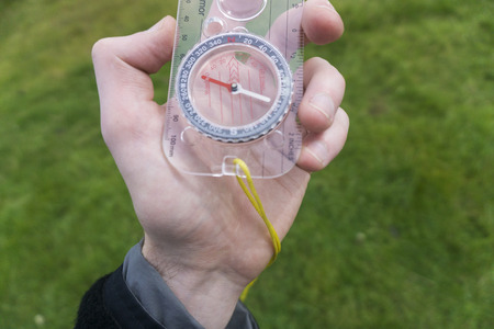 Male explorer with a compass in her hand. Point of viewの写真素材