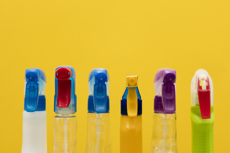 Cleaning spray bottle products on a bright yellow backgroundの写真素材