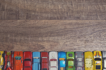 vintage toy cars on a wooden backgroundの写真素材