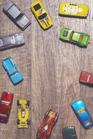 vintage toy cars on a wooden backgroundの写真素材