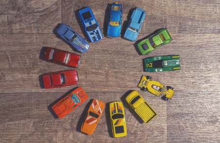 vintage toy cars on a wooden backgroundの写真素材