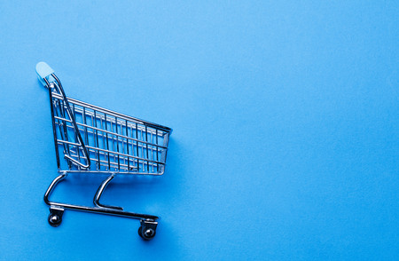 Shopping cart on a blue backgroundの写真素材