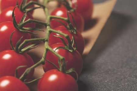 Red cherry vine tomatos on a slate backgroundの写真素材