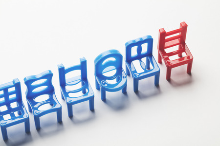 Row of chairs with one odd one out. Job opportunity. Business leadership. recruitment concept.の写真素材
