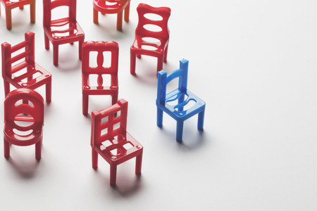 Collection of chairs with one odd one out.の写真素材