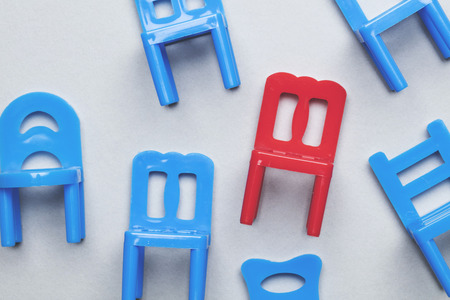 Collection of chairs with one odd one out.の写真素材