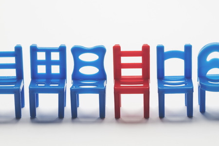 Row of chairs with one odd one out. Job opportunity. Business leadership. recruitment concept.の写真素材