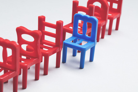 Row of chairs with one odd one out. Job opportunity. Business leadership. recruitment concept.の写真素材