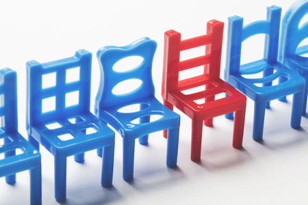 Row of chairs with one odd one out. Job opportunity. Business leadership. recruitment concept.の写真素材