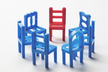Circle of chairs with one odd one out.の写真素材