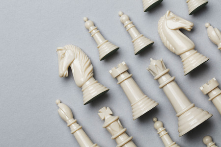 Chess game pieces on a grey background. Strategy conceptの写真素材