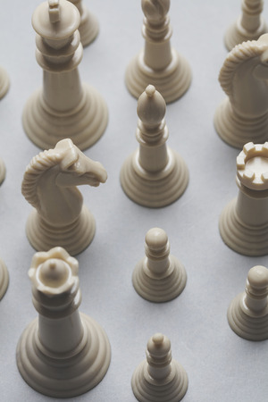 Chess game pieces on a grey background. Strategy conceptの写真素材