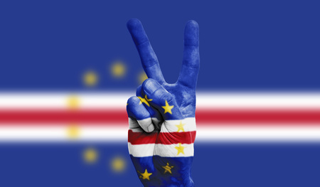 Cape Verde national flag painted onto a male hand showing a victory, peace, strength signの写真素材
