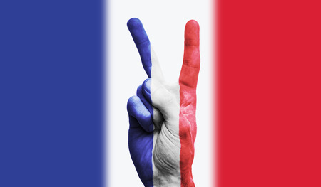 France national flag painted onto a male hand showing a victory, peace, strength signの写真素材